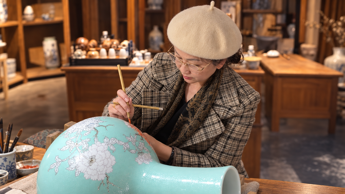 Jingdezhen artist Ying Shengxiang hand-painting floral details on a turquoise porcelain vase