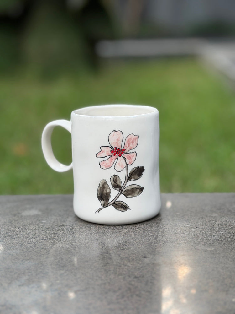 Blue Tulip hand-painted mug with coffee on a balcony
