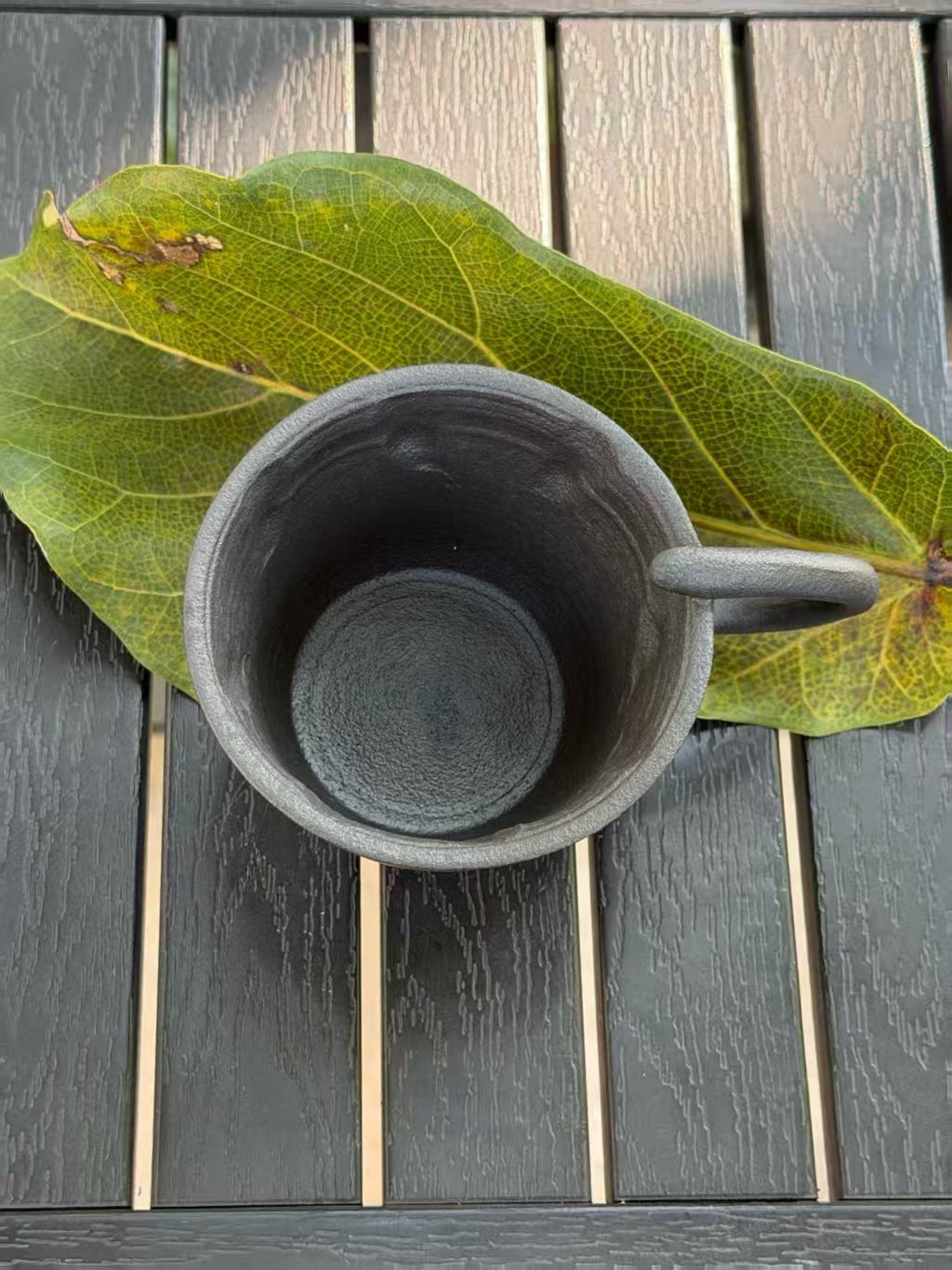 Top view of 220 ml black ceramic cat cup showing its dark glazed interior