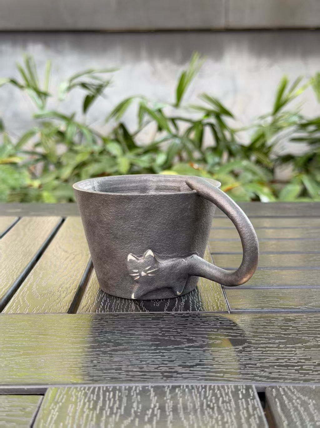Black cat sculptural ceramic cup with textured dark glaze and curved tail handle, 220 ml