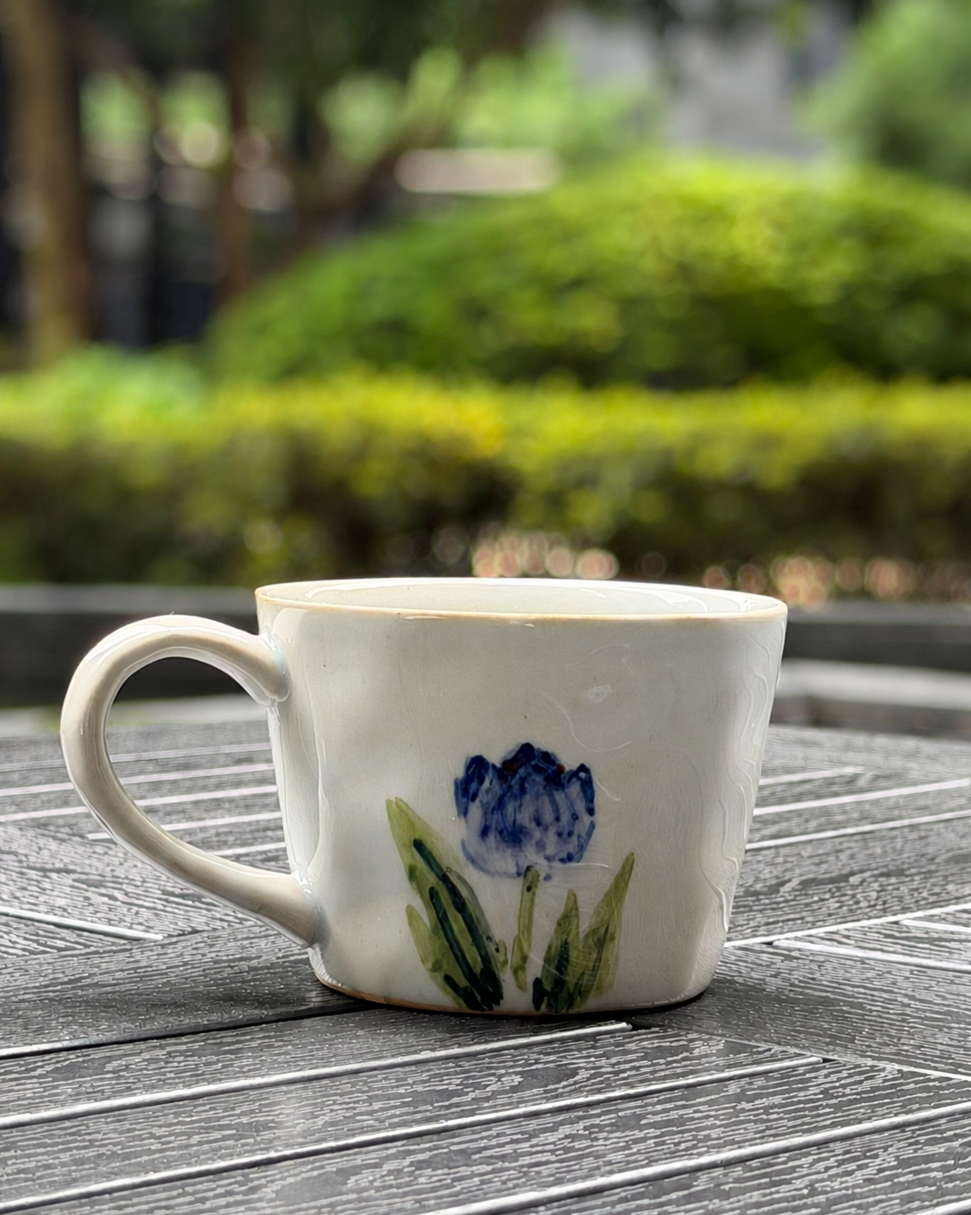 Back view of Blue Tulip hand-painted ceramic mug showing brushwork detail