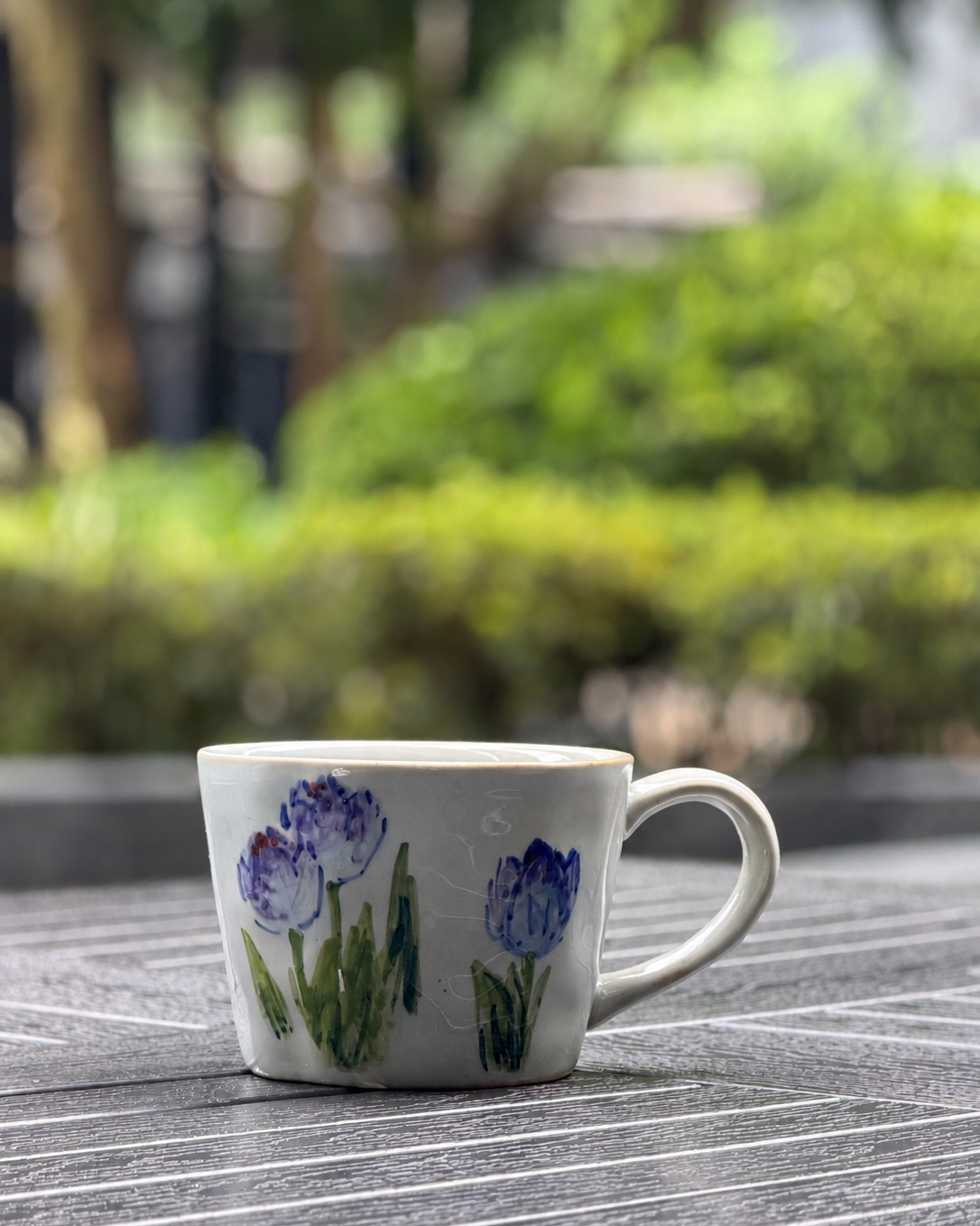 Front view of Blue Tulip hand-painted ceramic mug with soft blue tulip underglaze design