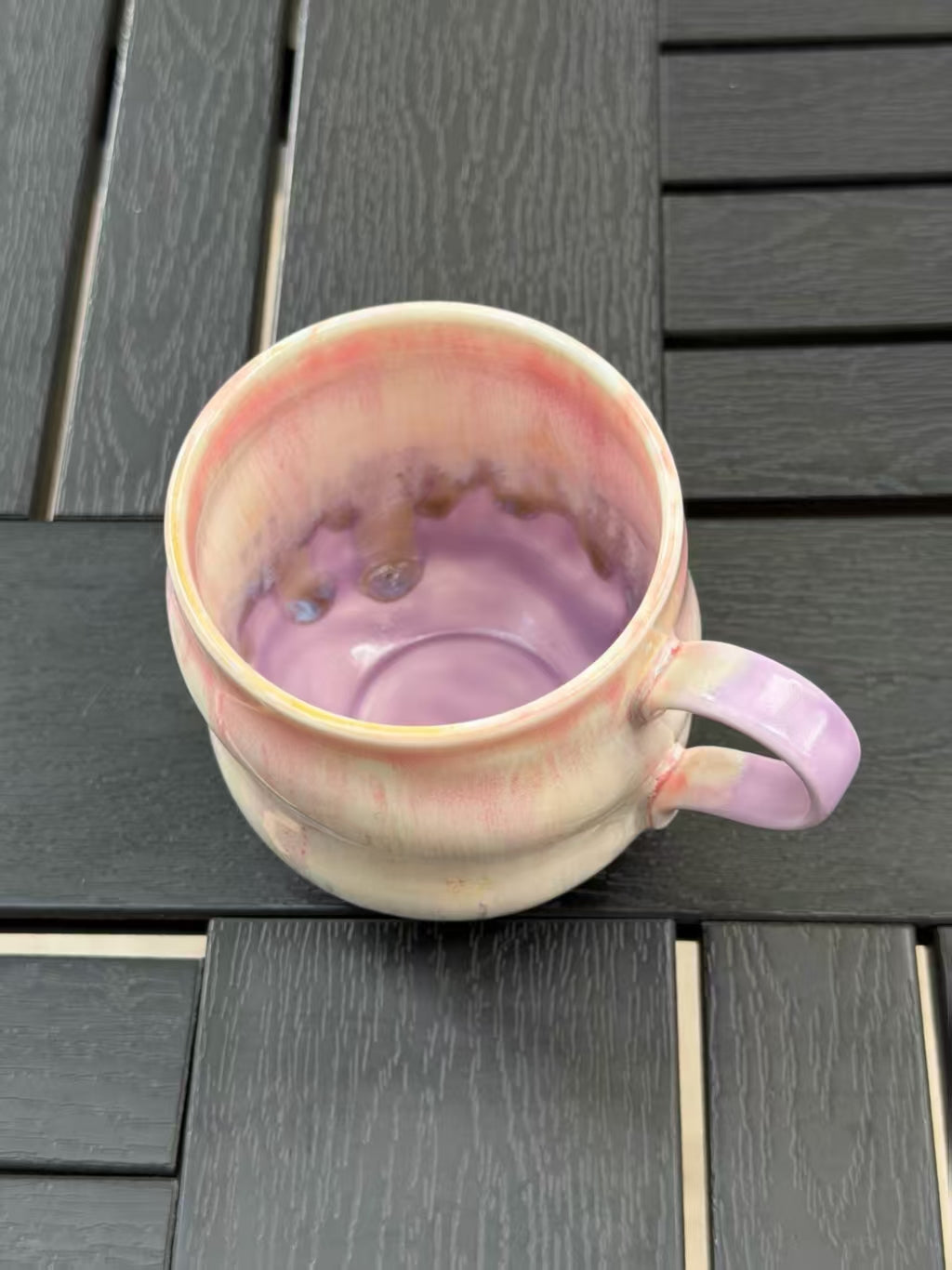 Overhead view inside the mug showing pink glaze near the rim blending into a lavender interior.