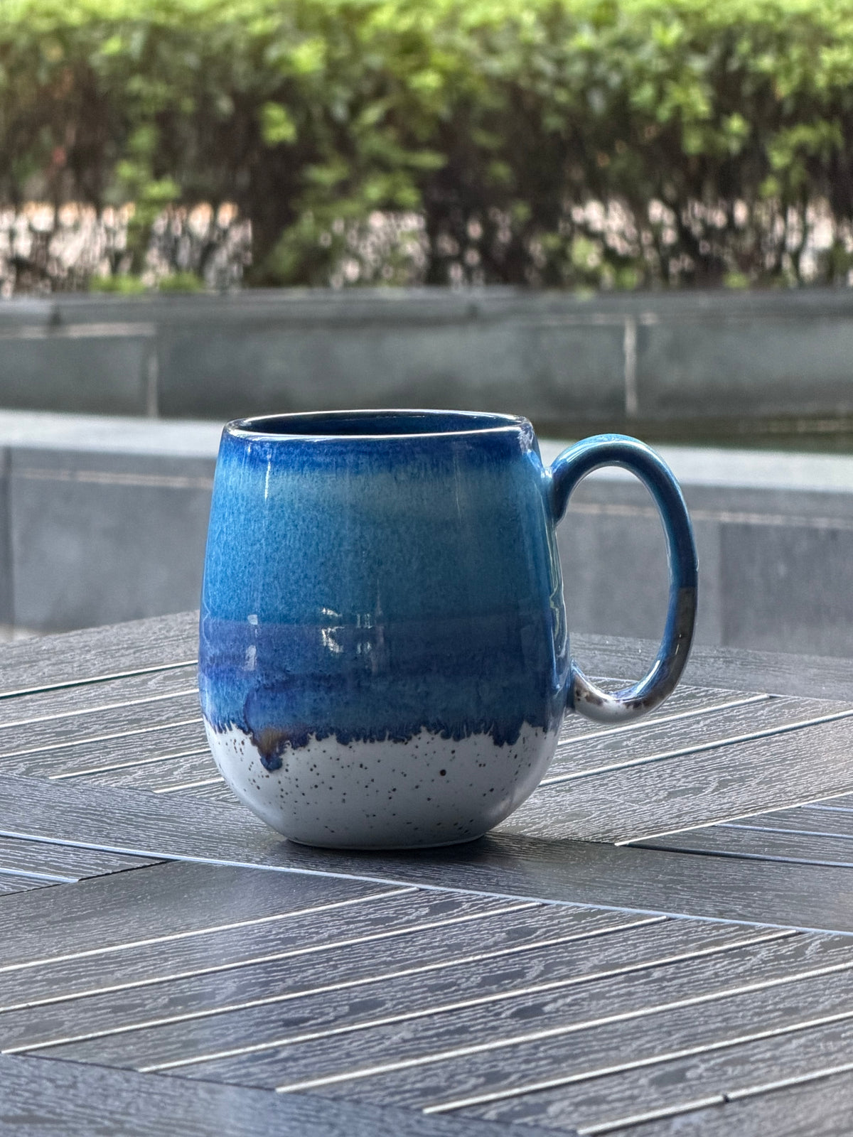 Coastal Tide ceramic mug with ocean blue and violet glaze transitioning naturally into warm speckled cream