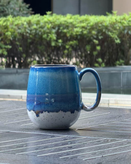 Coastal Tide oversized 27 oz reactive glaze ceramic mug with ocean blue, violet and speckled cream layers