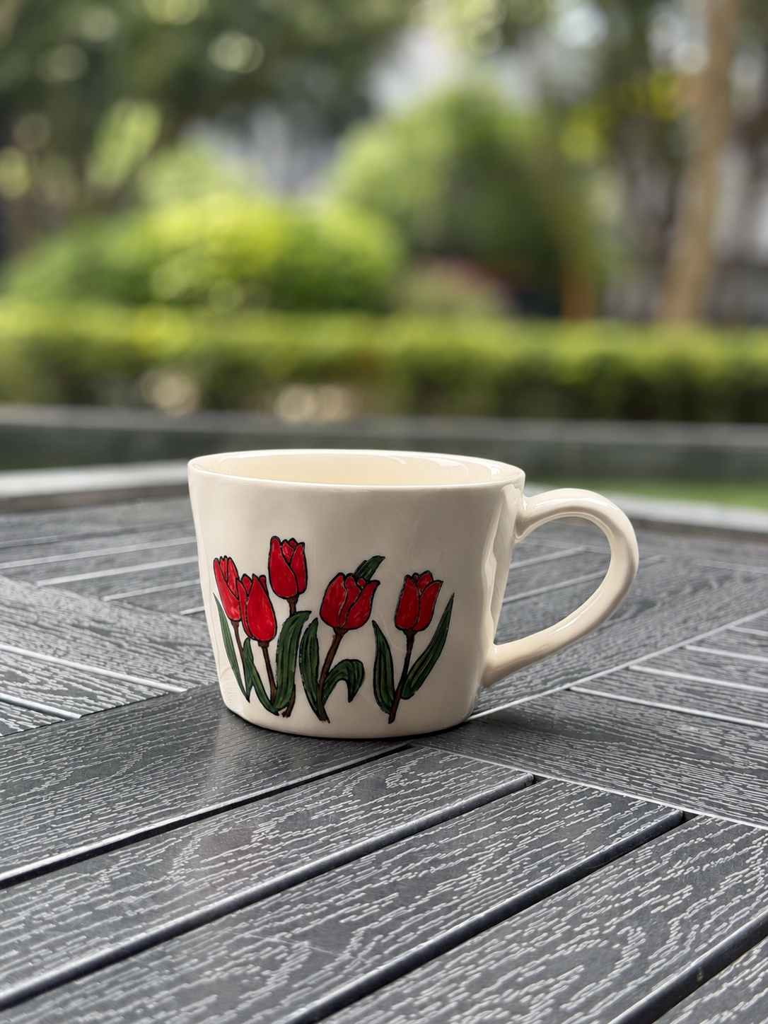 Crimson Tulip Garden hand-painted ceramic coffee mug with red flowers and a warm cream glaze