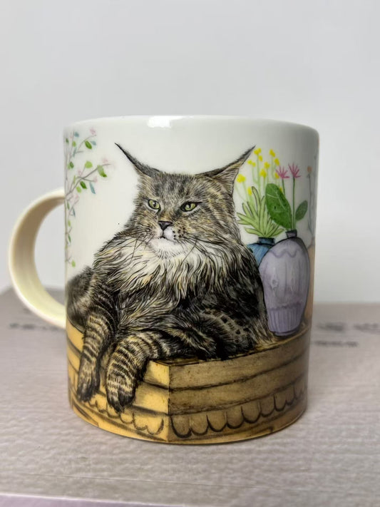 Custom hand-painted Maine Coon pet portrait mug with detailed fur and botanical accents