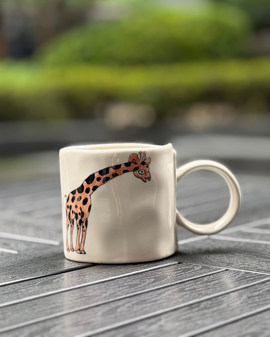 Gentle Giraffe Hand-Painted Ceramic Mug – main product view showing hand-painted giraffe wrapping around the mug body, The Quiet Clay