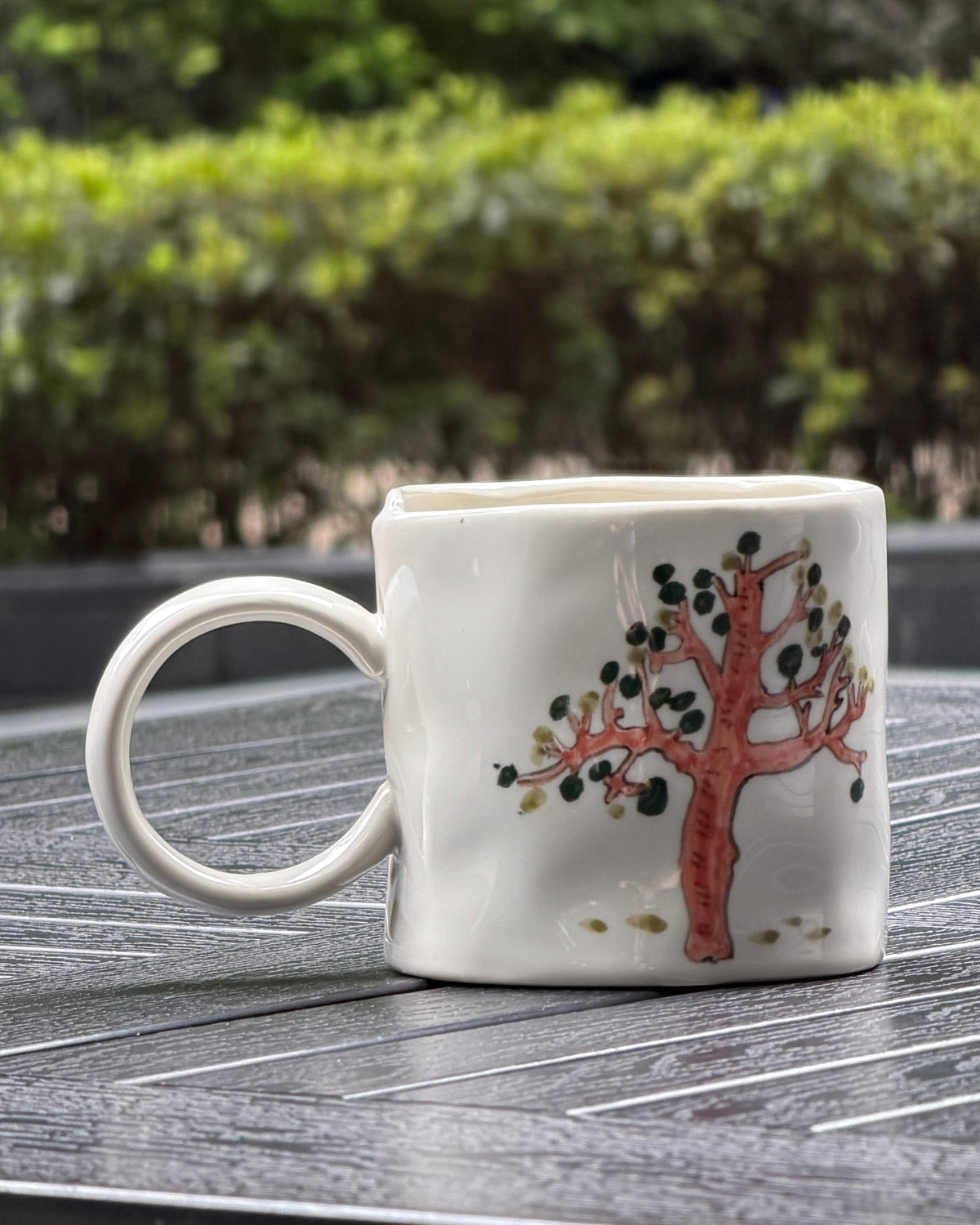 Hand-painted tree motif on ceramic mug, pink tree with dark green leaves on ivory glaze, The Quiet Clay