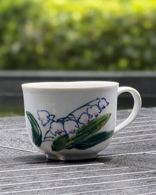 Lily of the Valley Hand-Painted Ceramic Mug – front view showing white bell-shaped flowers with pink tips and green leaves, The Quiet Clay