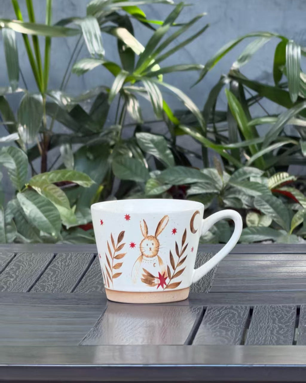 Moonlit Rabbit ceramic mug with a whimsical rabbit, crescent moon, stars and botanical design