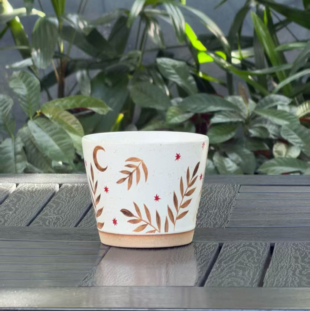 Back view of the Moonlit Rabbit ceramic mug with crescent moon, stars and botanical branch details