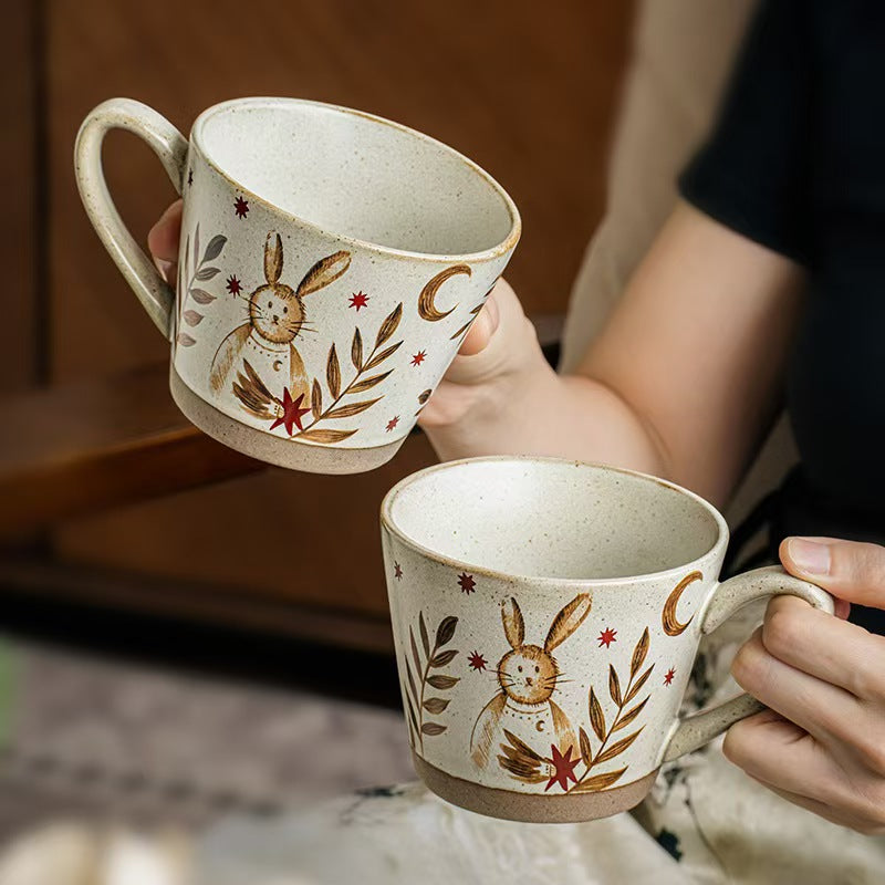 Two Moonlit Rabbit ceramic mugs showing the speckled glaze and illustrated woodland design