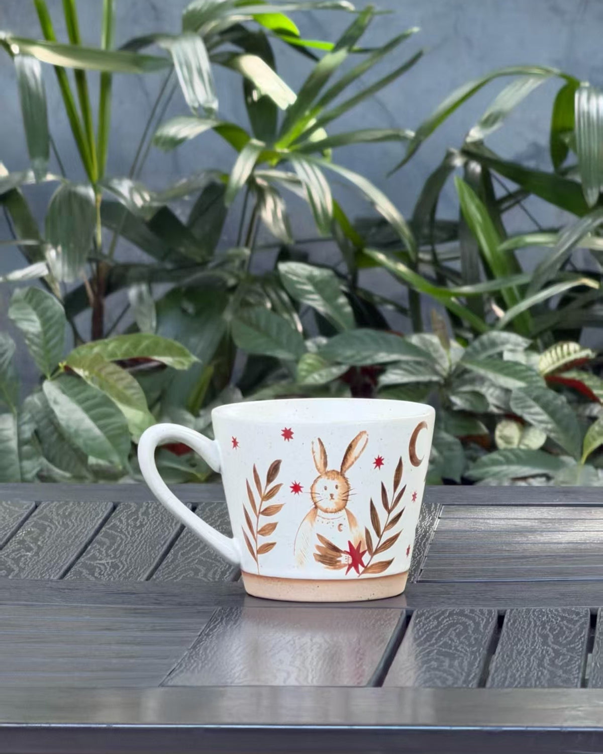 Moonlit Rabbit ceramic mug with a speckled cream glaze, rabbit, crescent moon, stars and botanical motifs