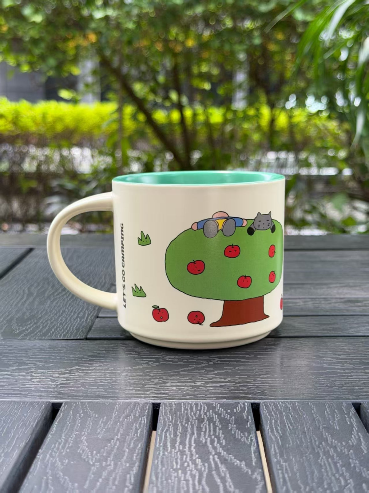 Reverse side of the Mint Green mug featuring a green apple tree with red fruit.