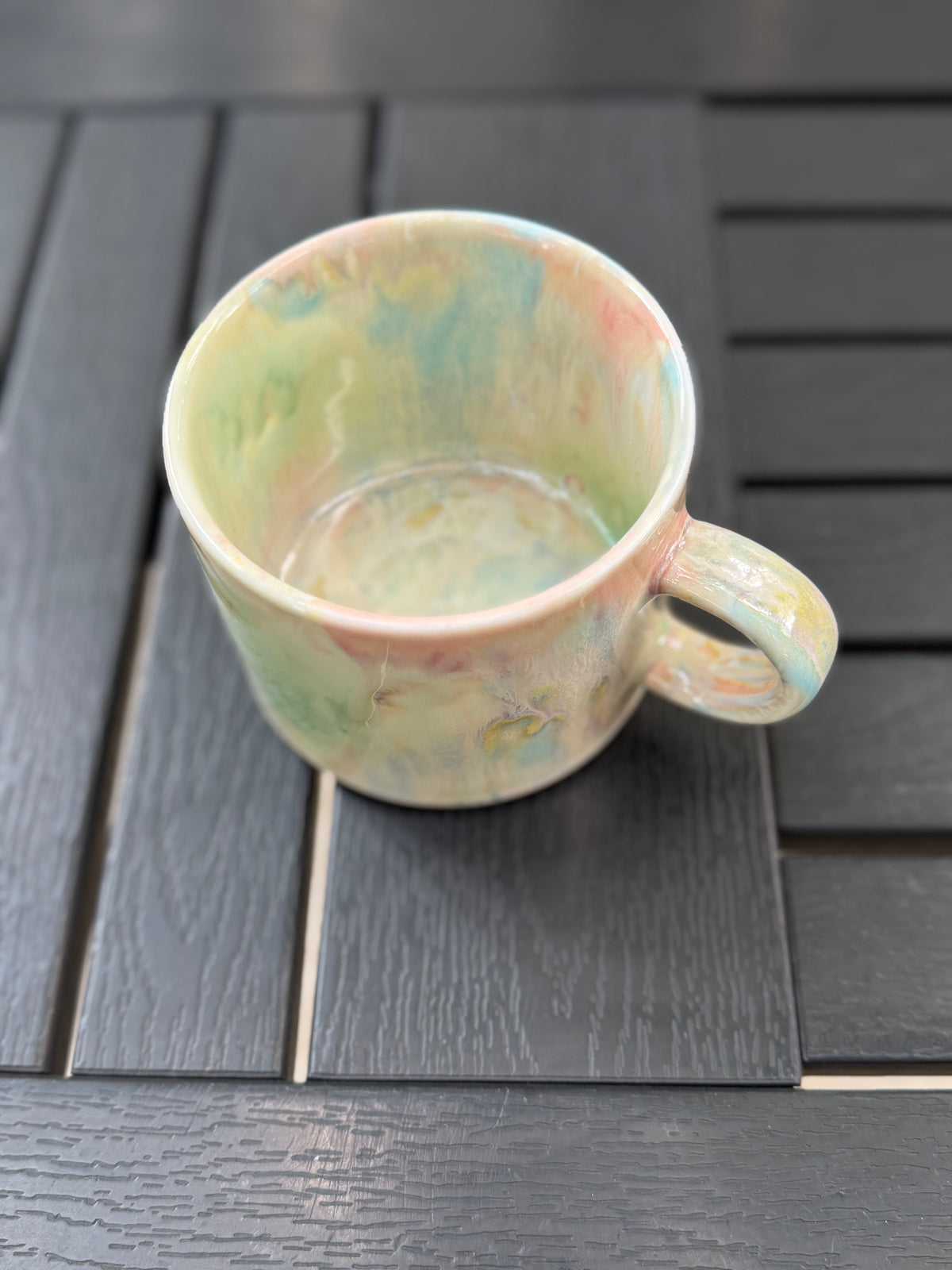 Angled overhead view of the mug showing its glazed interior, outer wall, and handle