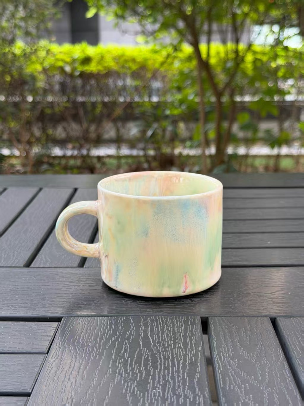 Reverse side of the Pastel Meadow mug showing pale green and warm cream glaze variations