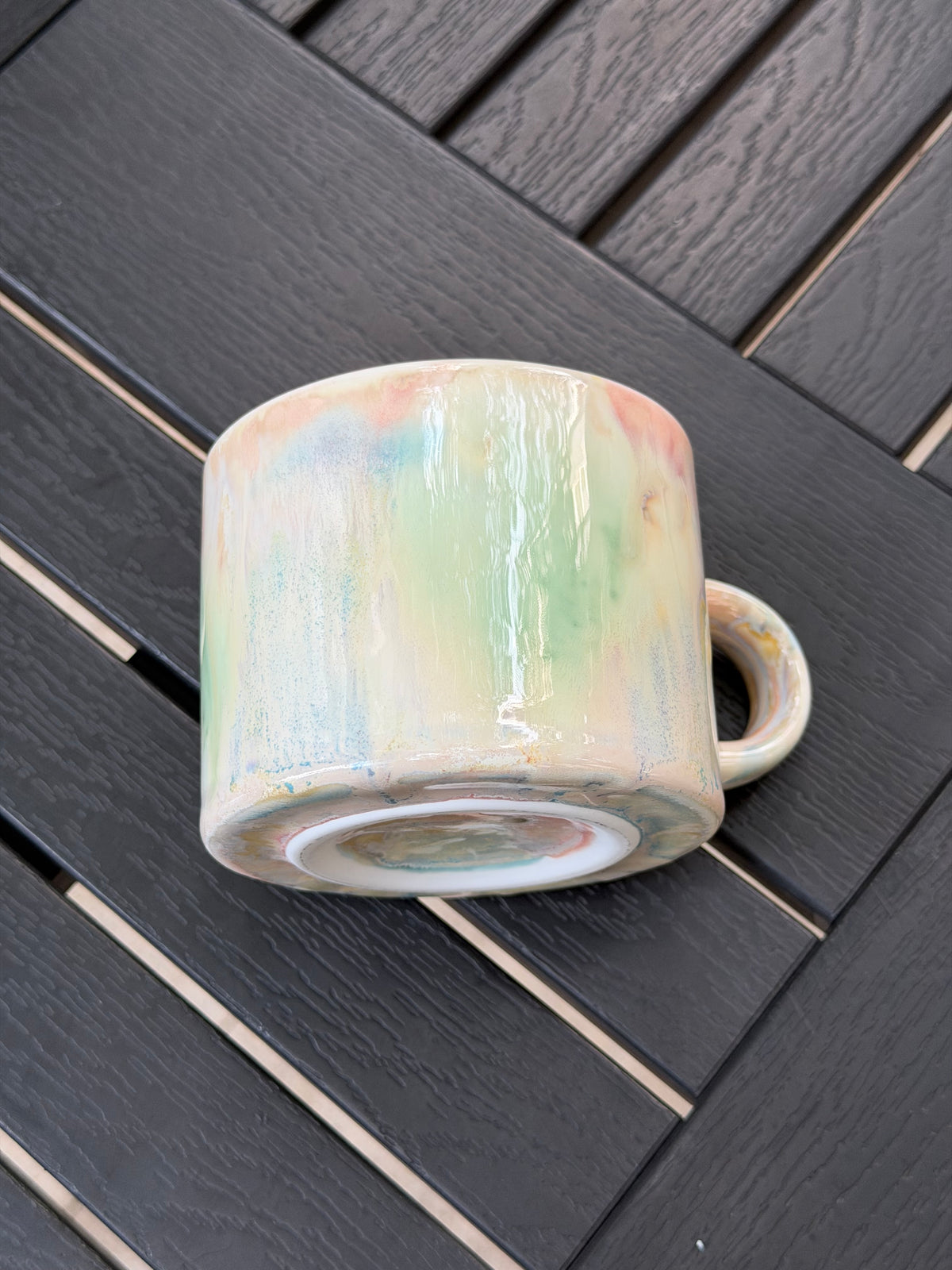 Pastel Meadow mug resting on its side, showing the exterior glaze and base