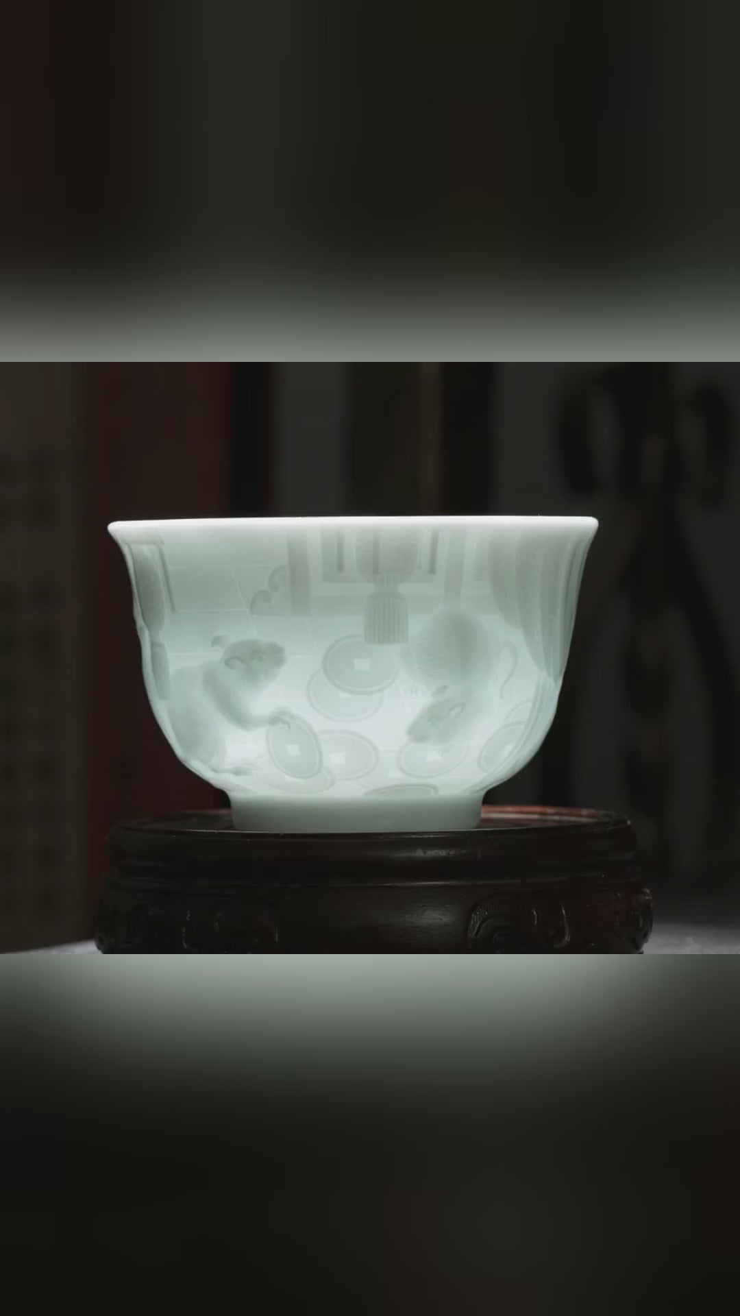 The Great Zodiac hand-carved porcelain tea cup by Jingdezhen artist Yan Wenlu, showing the detailed zodiac relief