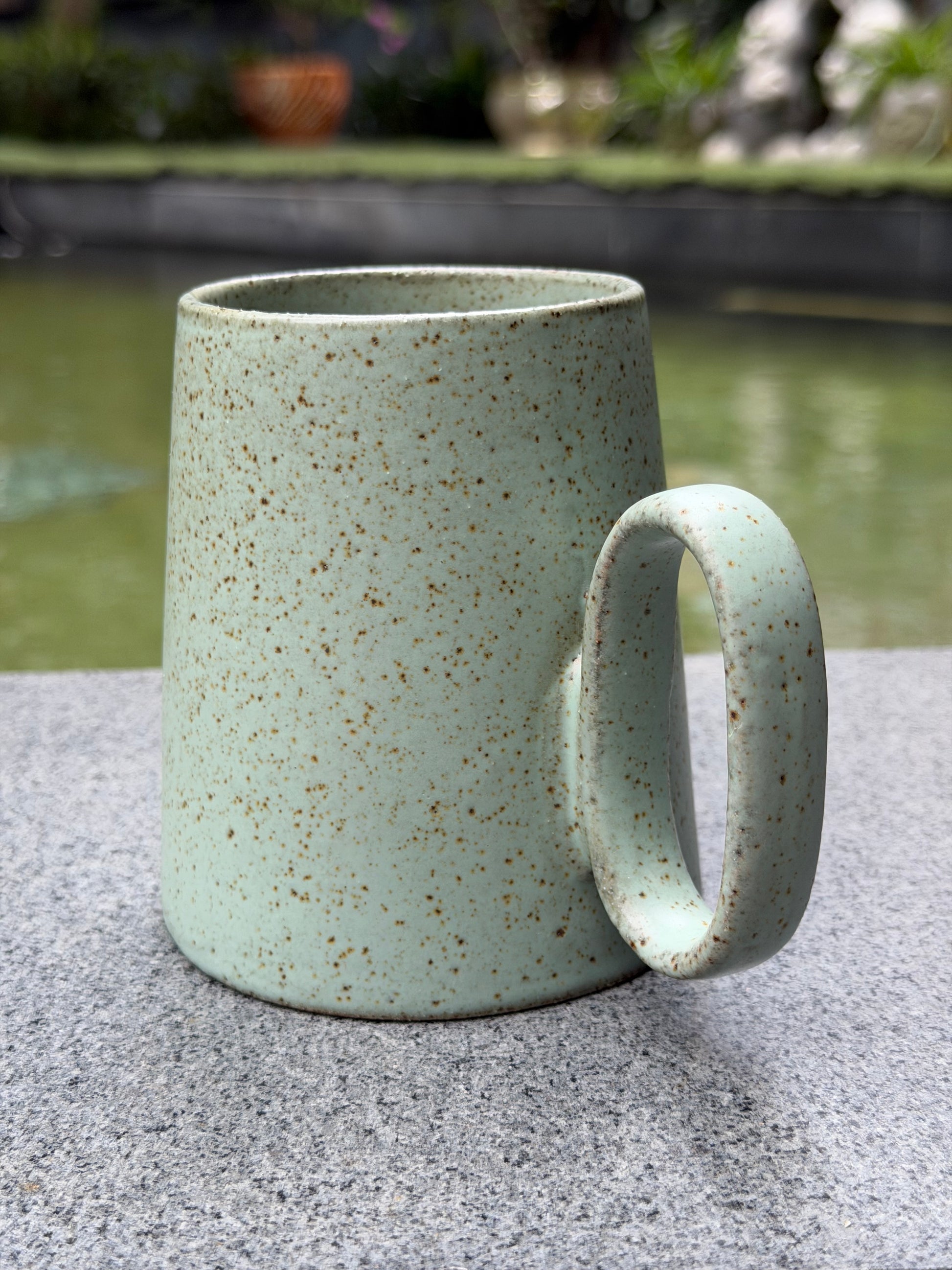 Quiet Meadow Mug – side view highlighting the round loop handle and wide-base tapered stoneware body