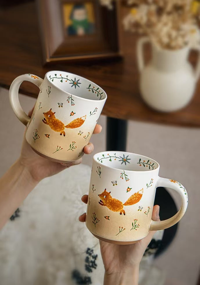 Two Running Fox ceramic mugs with wildflower motifs and botanical interior details