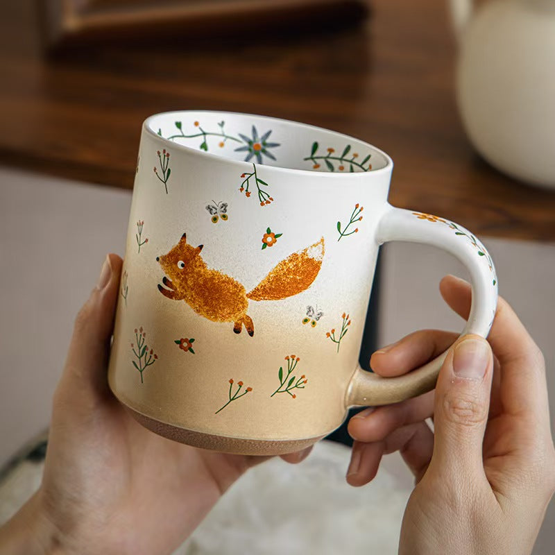 Large Running Fox ceramic mug held in both hands showing its generous size