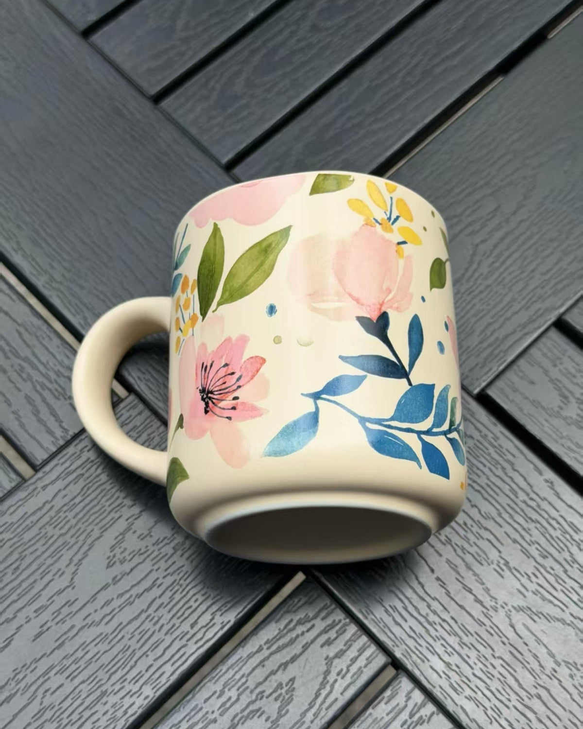 Soft Bloom floral ceramic mug shown from a low angle with its raised unglazed foot ring visible