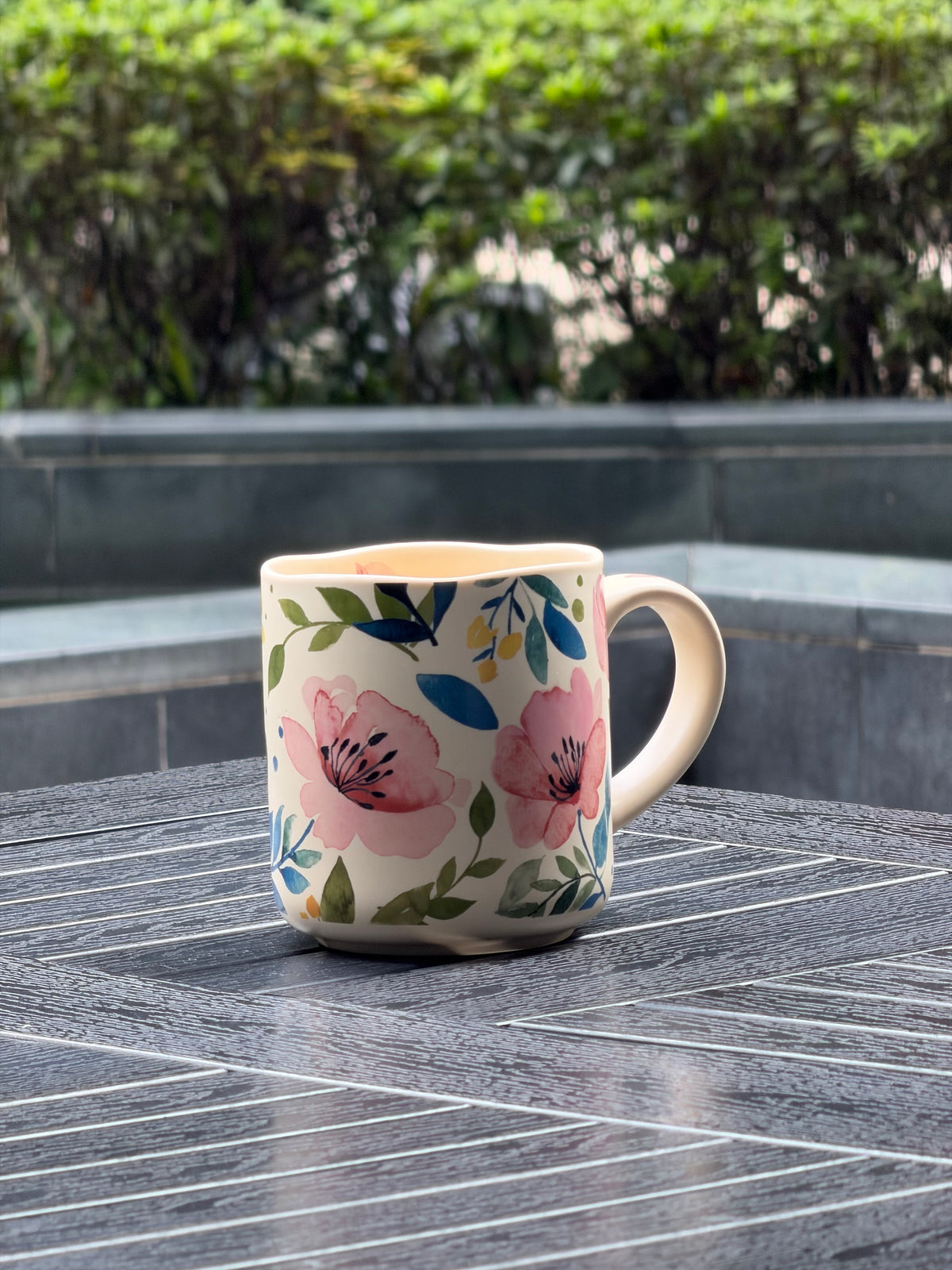 Side view of Soft Bloom ceramic mug with large pink flowers and watercolor-style leafy details