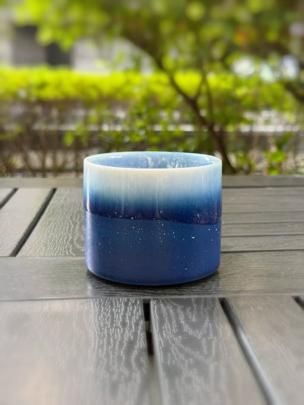 Side view with the handle hidden, showing the glaze changing from pale blue to deep blue