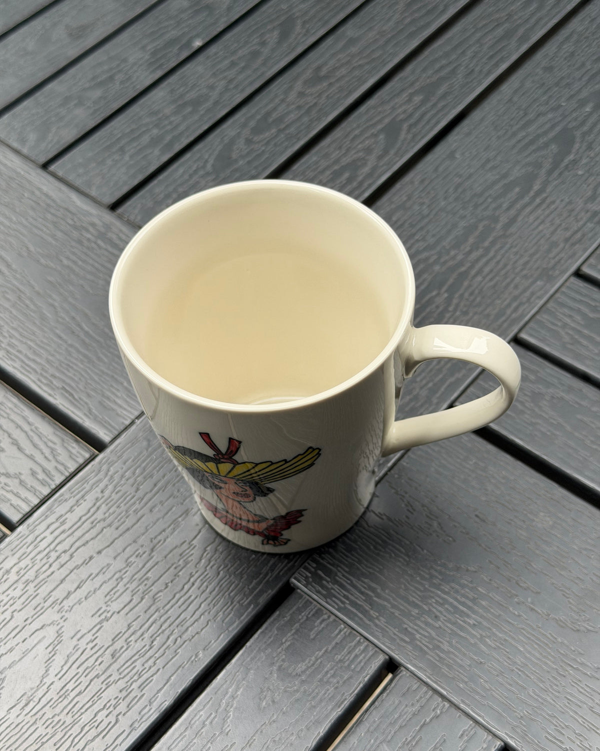 Top view of the Sunflower Muse hand-painted ceramic mug showing its ivory glazed interior and curved handle.