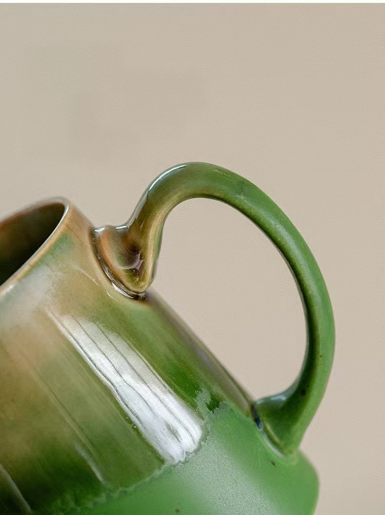Handle detail of green ceramic pour-over coffee server