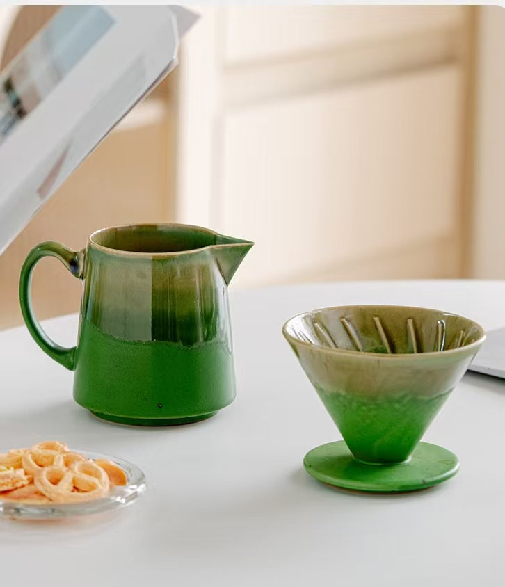 Green ceramic pour-over dripper lifted off server showing removable design
