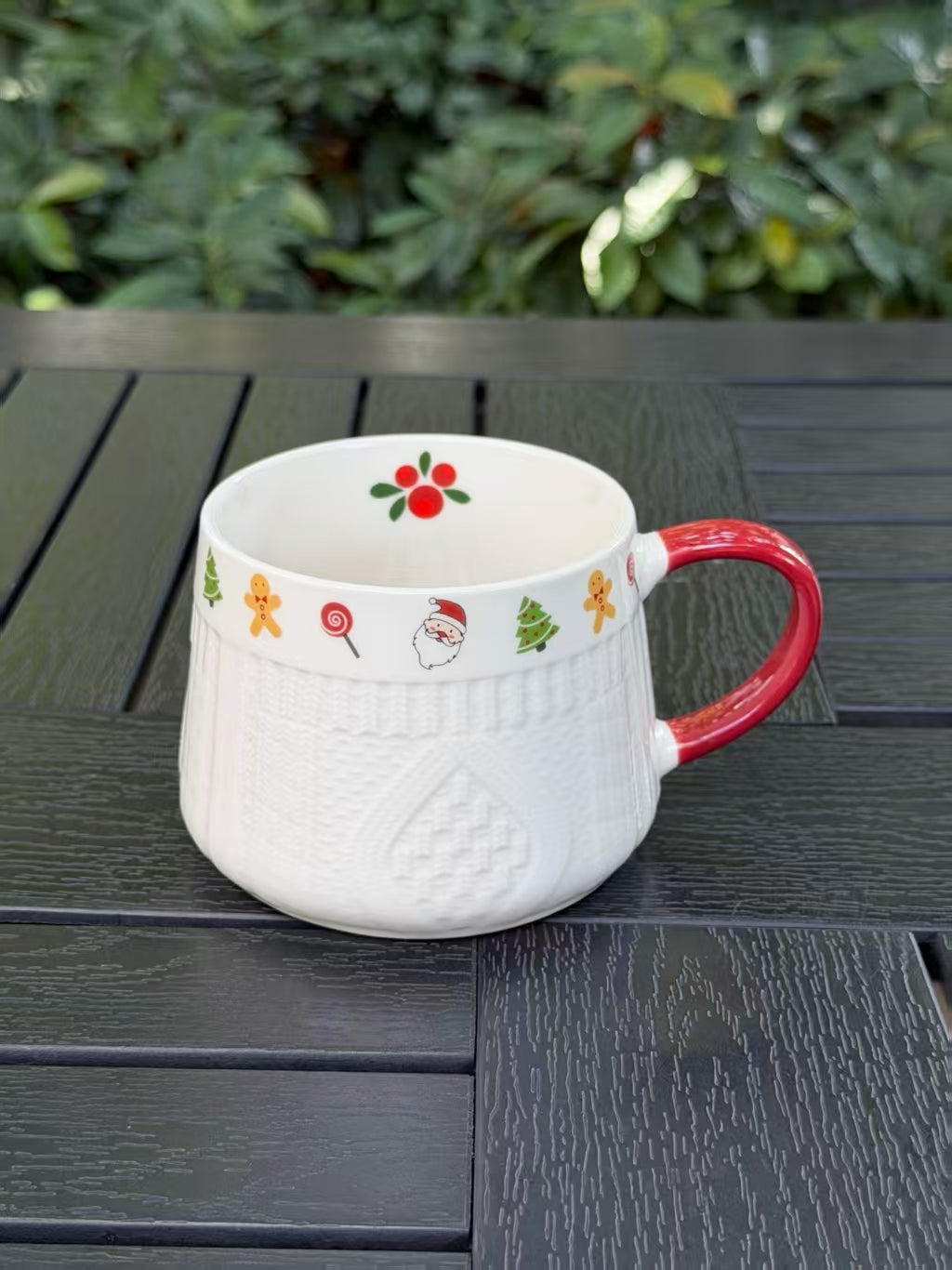 Winter Knit holiday ceramic mug showing Christmas motifs and interior berry detail