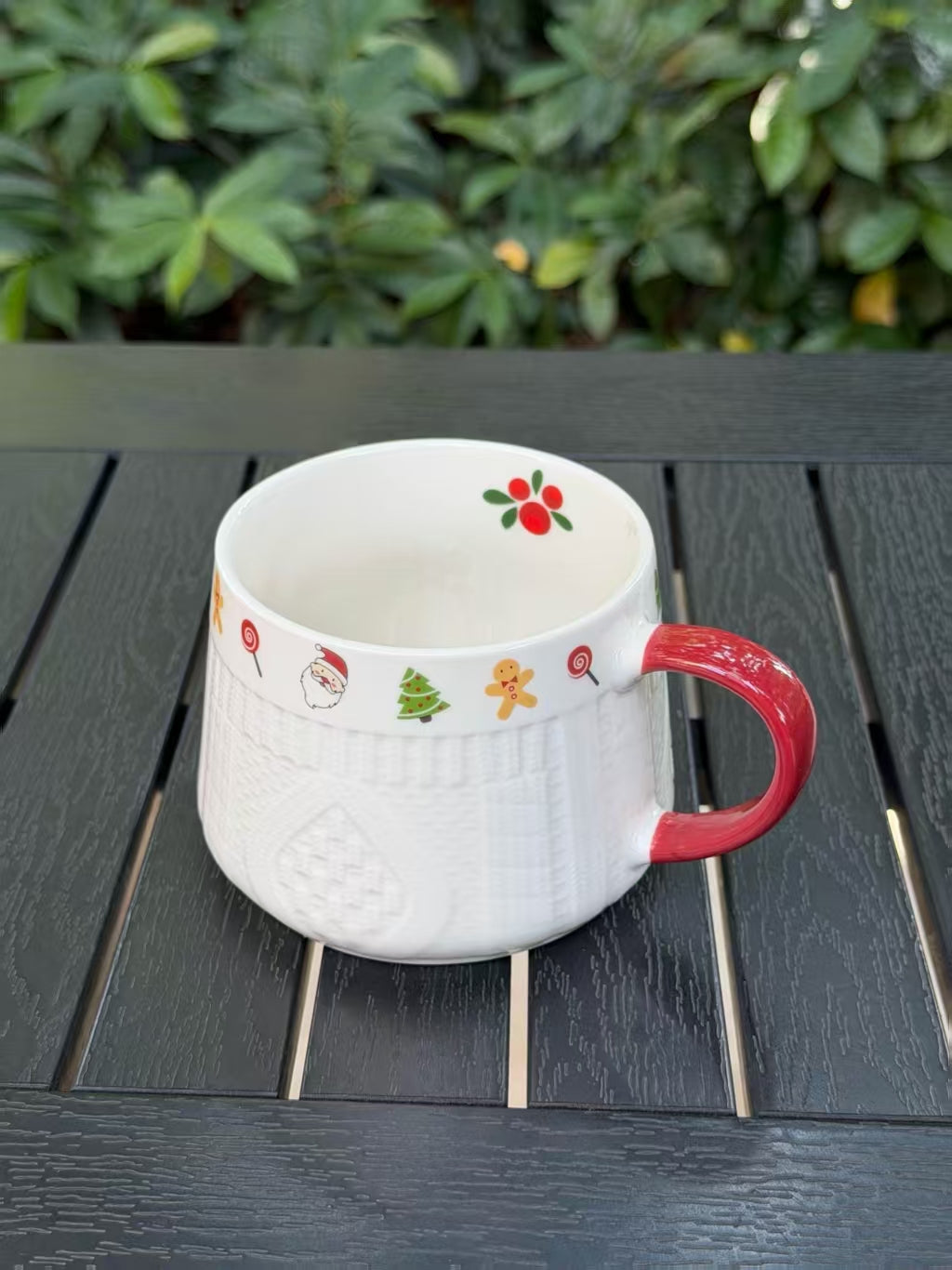 Winter Knit holiday ceramic mug showing its wide opening, festive border and red handle