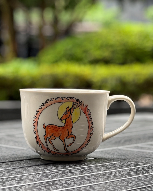 Woodland Deer hand-painted ceramic mug, main view showing deer illustration in circular motif on ivory glaze, The Quiet Clay