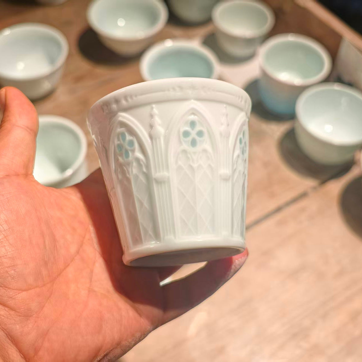 Hand-carved Linglong porcelain cup viewed from another angle with raised geometric decoration