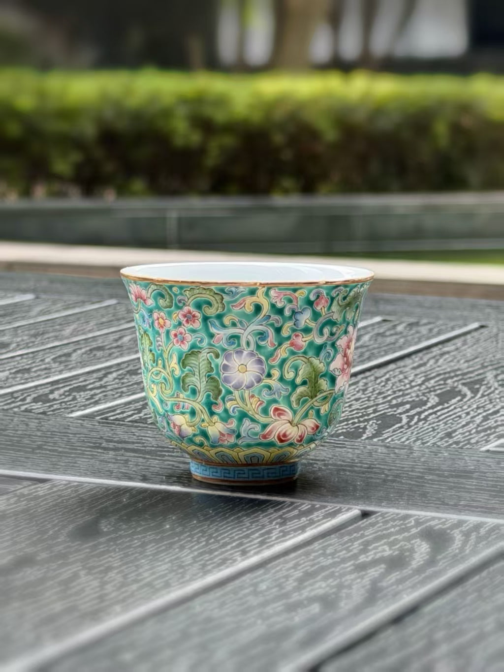 Enamel-painted porcelain teacup by Ying Shengxiang with pink flowers and turquoise foliage
