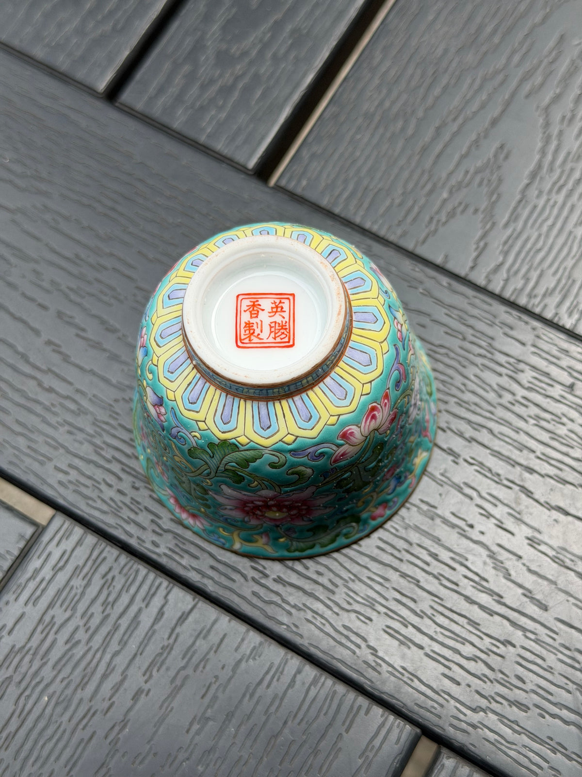 Base of Ying Shengxiang’s porcelain teacup showing the red artist’s mark and decorative border