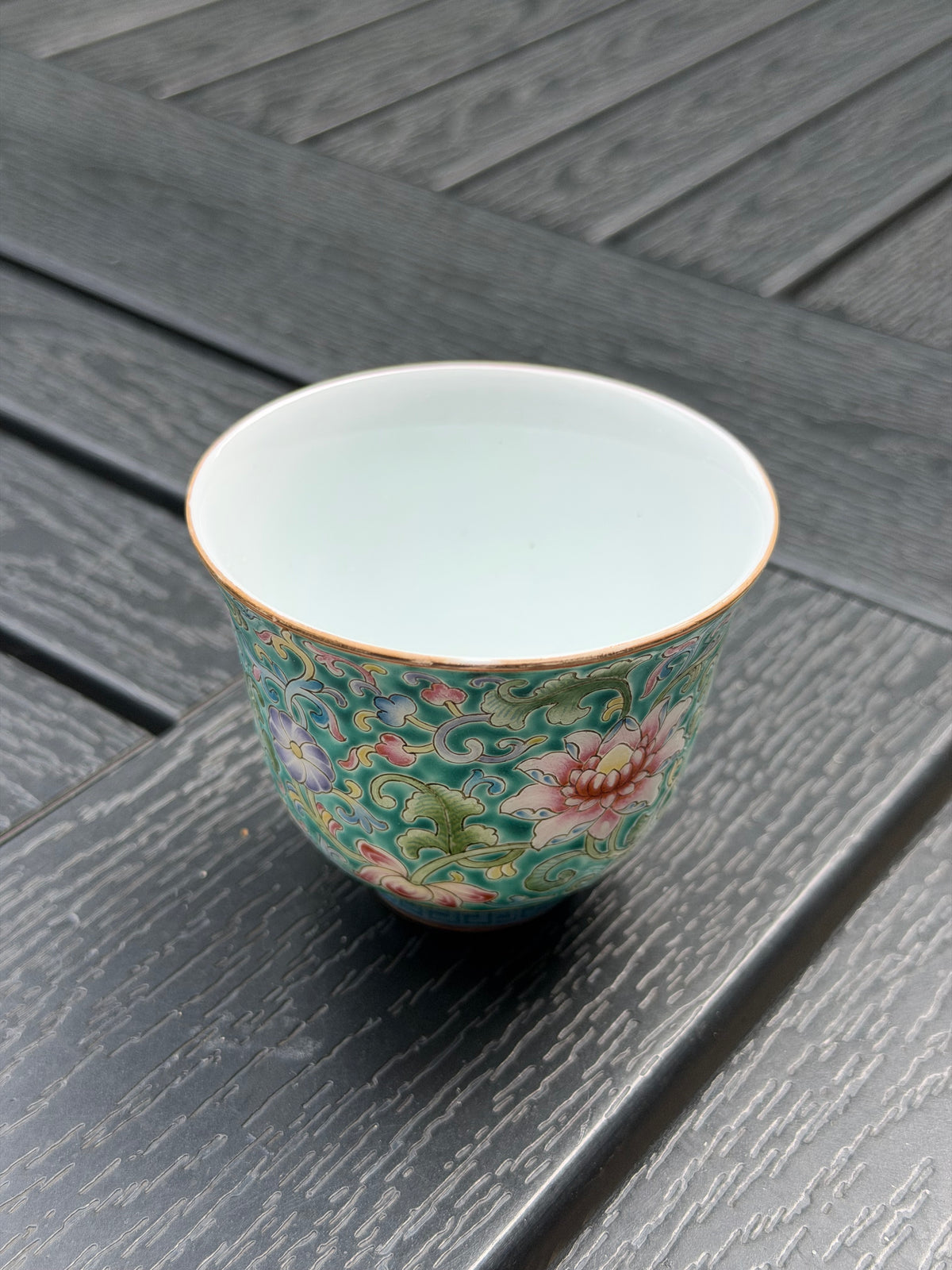 Top view of the floral porcelain teacup showing its plain white interior